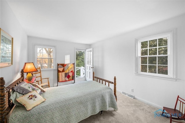 bedroom with light carpet, baseboards, and visible vents