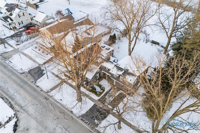 snowy aerial view with a residential view