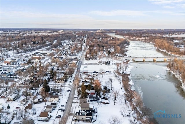 snowy aerial view with a water view