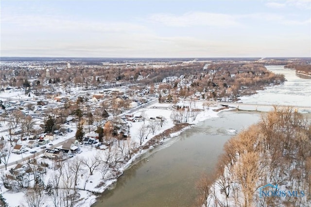 snowy aerial view featuring a water view