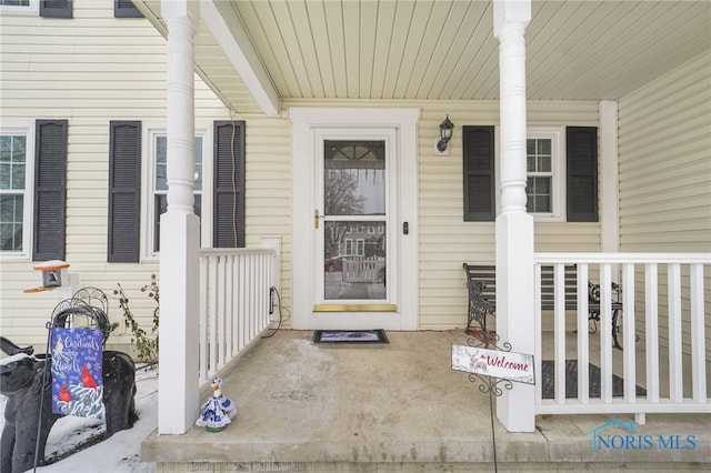 view of exterior entry featuring a porch