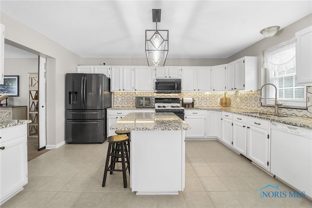 kitchen featuring a sink, black fridge with ice dispenser, dishwasher, stainless steel microwave, and gas stove