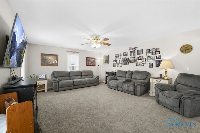 living area featuring carpet and ceiling fan