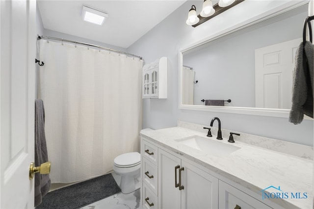 full bathroom with toilet, marble finish floor, a shower with curtain, and vanity