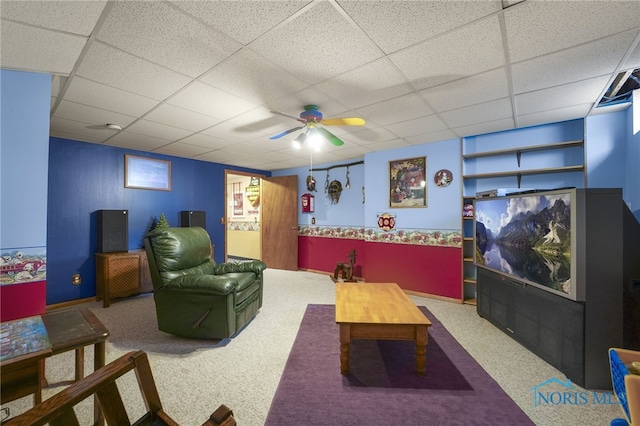 home theater room featuring a ceiling fan, carpet, and a drop ceiling