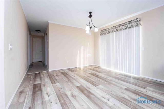 20391 Brown Ln, Weston, OH 43569 - unfurnished dining area with baseboards, crown molding, an inviting chandelier, and light wood-style floors