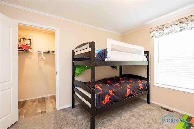 20391 Brown Ln, Weston, OH 43569 - carpeted bedroom featuring visible vents, baseboards, a closet, a walk in closet, and crown molding