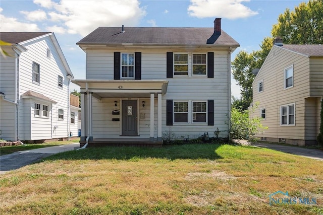 view of front facade featuring a porch, a chimney, and a front yard