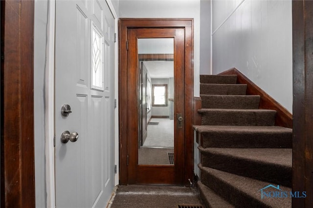 stairs featuring carpet