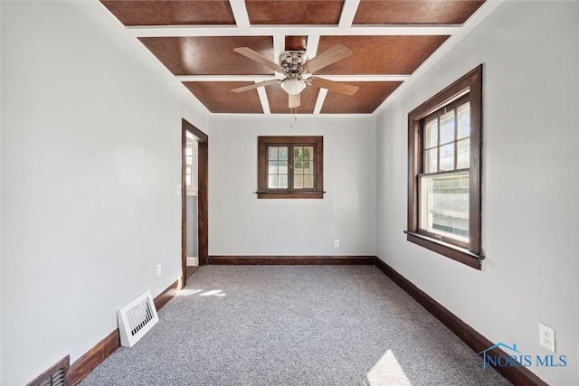 unfurnished room featuring plenty of natural light, coffered ceiling, visible vents, and baseboards