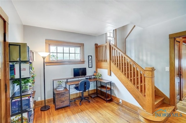 office space featuring light wood-type flooring and baseboards