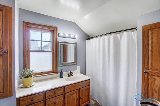 bathroom featuring lofted ceiling, vanity, and a shower with curtain