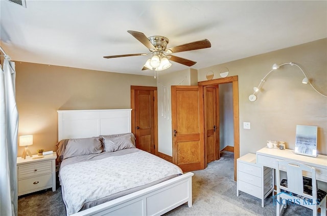 bedroom featuring ceiling fan, visible vents, and light colored carpet