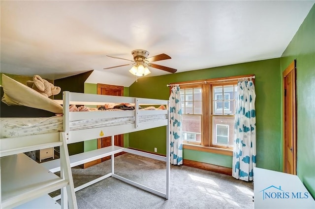 unfurnished bedroom with carpet floors, baseboards, and a ceiling fan