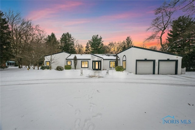 view of front of property with a garage and stucco siding