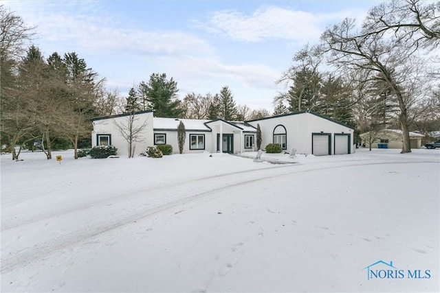 view of front of property with a garage and stucco siding