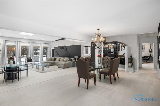 dining area featuring light wood-type flooring, an inviting chandelier, and recessed lighting