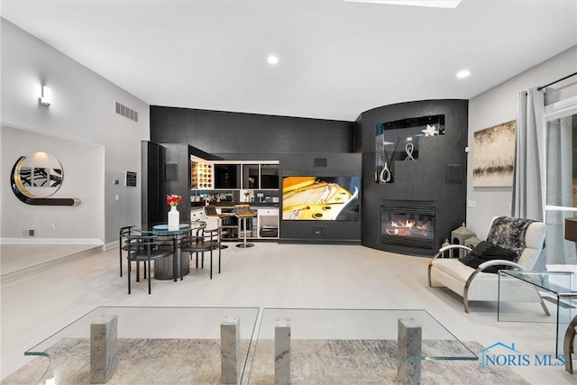 dining room featuring a large fireplace, baseboards, visible vents, and recessed lighting