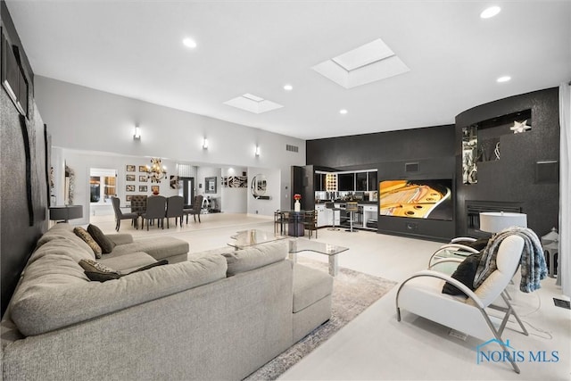 living area with a skylight, visible vents, a notable chandelier, and recessed lighting