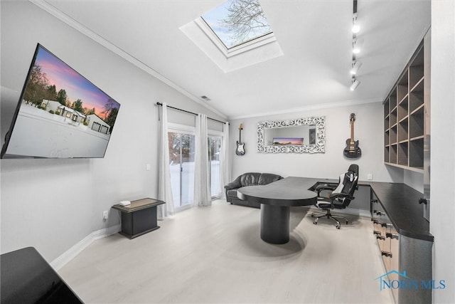 home office featuring vaulted ceiling with skylight, baseboards, wood finished floors, rail lighting, and crown molding