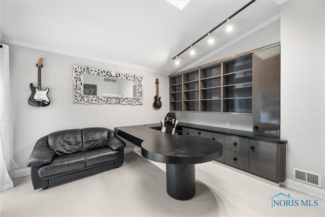 office featuring visible vents, baseboards, vaulted ceiling, rail lighting, and crown molding