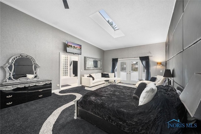 bedroom with carpet floors, french doors, lofted ceiling with skylight, a textured ceiling, and access to outside