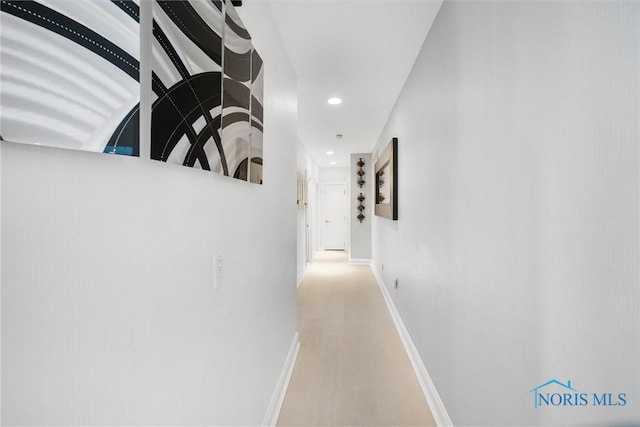 corridor featuring baseboards and recessed lighting