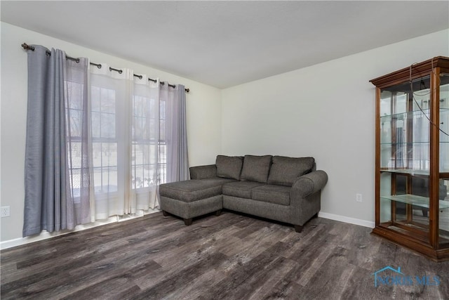 living room featuring dark wood-style floors and baseboards