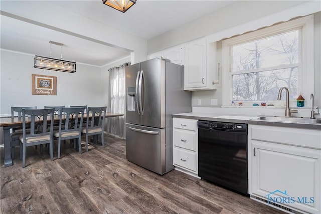 kitchen with pendant lighting, light countertops, white cabinetry, a sink, and dishwasher