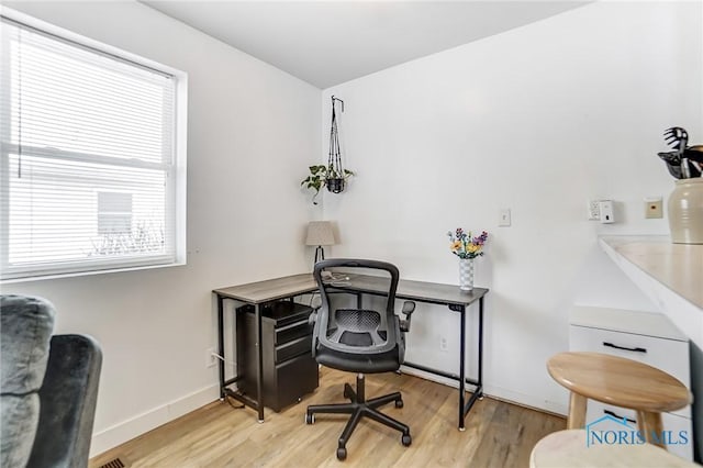 office with light wood-style floors and baseboards