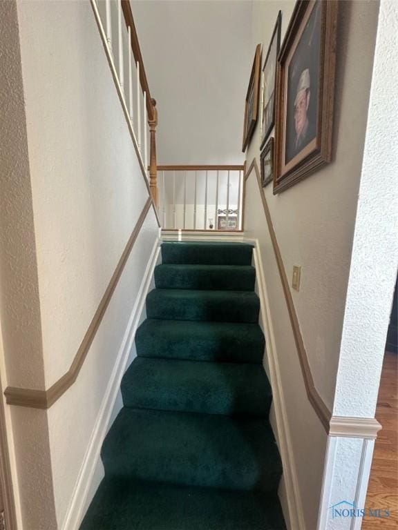 staircase featuring wood finished floors