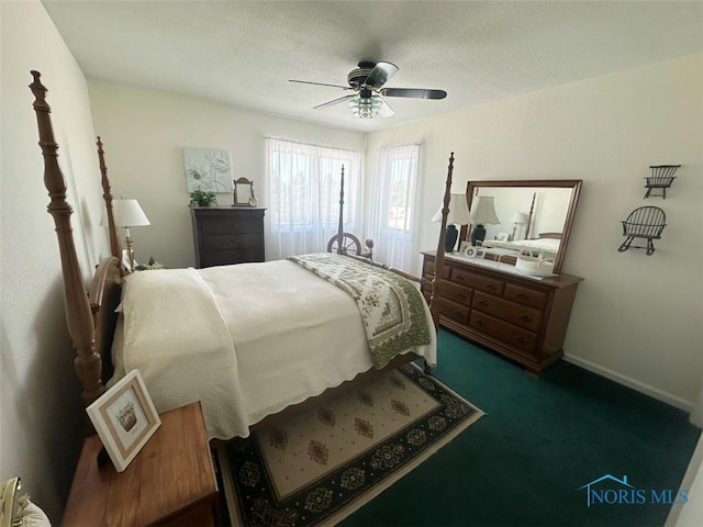 bedroom featuring dark carpet, a ceiling fan, and baseboards