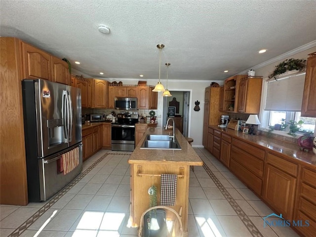 kitchen featuring decorative light fixtures, open shelves, appliances with stainless steel finishes, a sink, and an island with sink