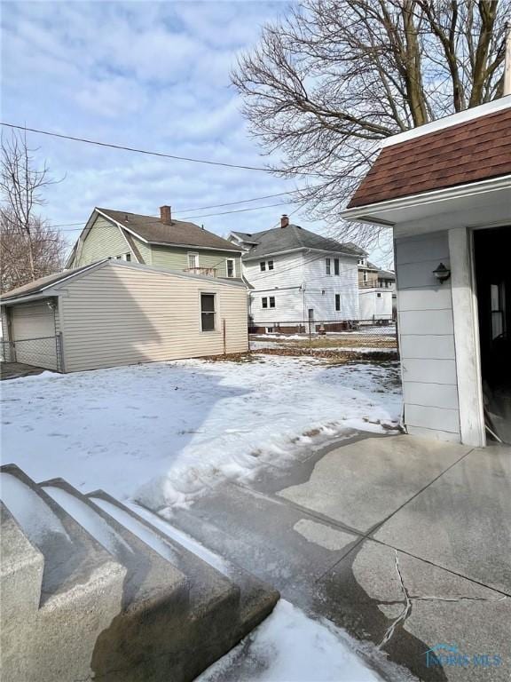 yard layered in snow featuring an outbuilding