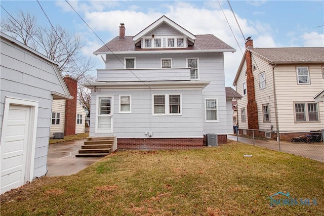 rear view of house featuring a lawn, a balcony, a chimney, fence, and central air condition unit