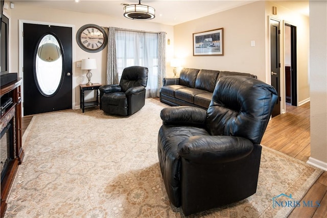 living area with wood finished floors and baseboards