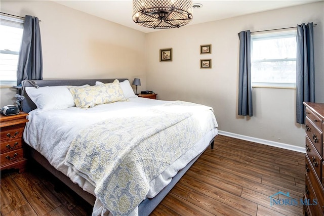 bedroom with dark wood-style floors and baseboards