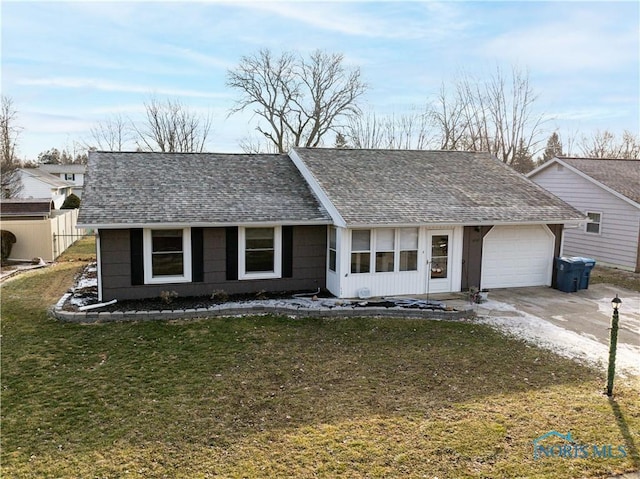 single story home with a garage, driveway, a shingled roof, and a front yard