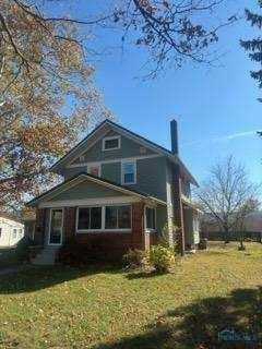 view of home's exterior with a lawn