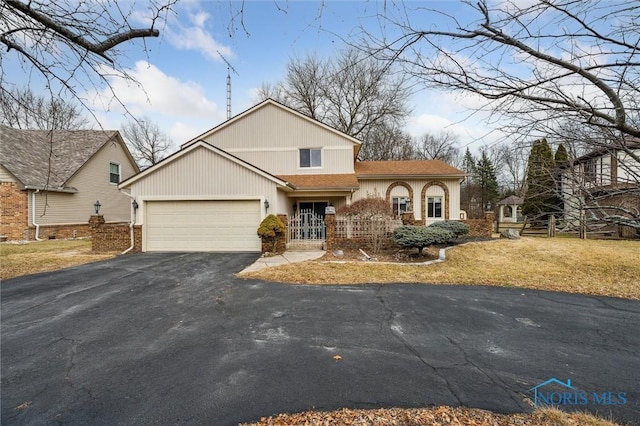 view of front of property with aphalt driveway, a shingled roof, and a garage