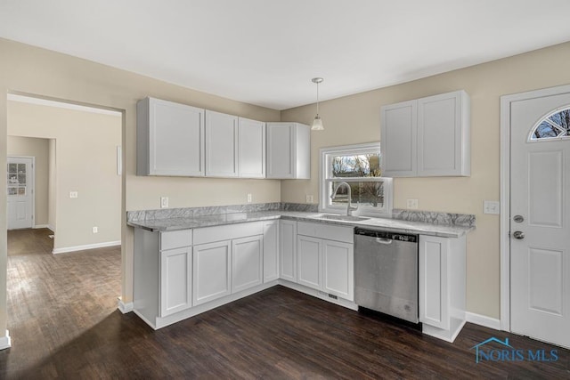 kitchen featuring white cabinets, dishwasher, decorative light fixtures, and a sink