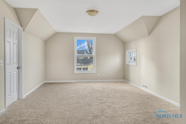 bonus room with lofted ceiling, carpet, visible vents, and baseboards