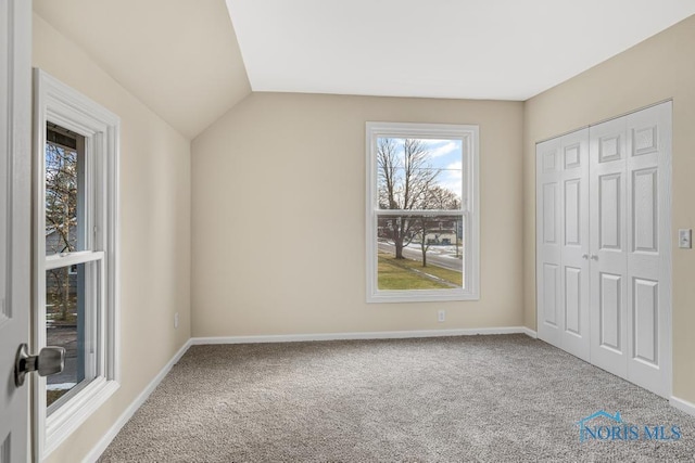 additional living space with carpet floors, baseboards, and vaulted ceiling