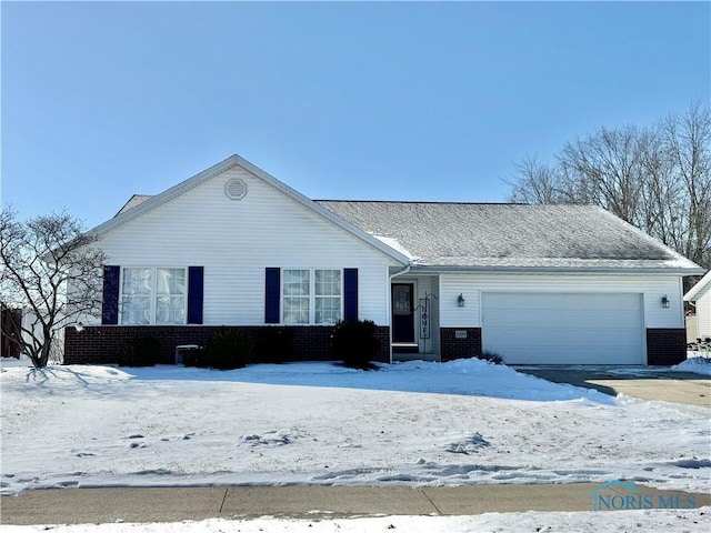 single story home with brick siding and an attached garage