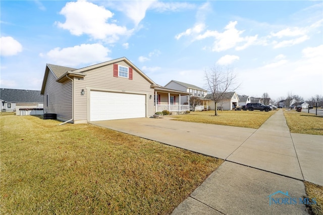 view of front of house with driveway, covered porch, a garage, and a front lawn