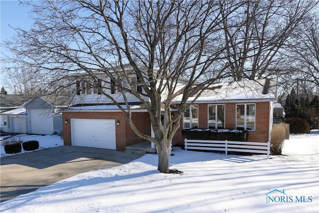 view of front of house with a garage, concrete driveway, and brick siding