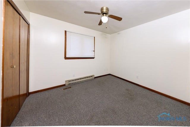 unfurnished bedroom featuring a baseboard heating unit, visible vents, baseboards, a closet, and carpet