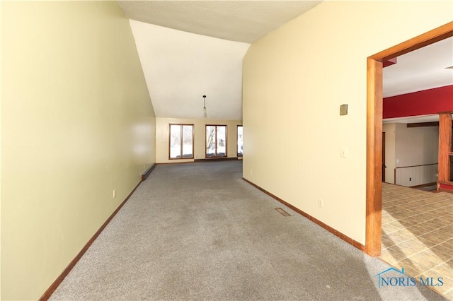 interior space with lofted ceiling, carpet floors, and baseboards