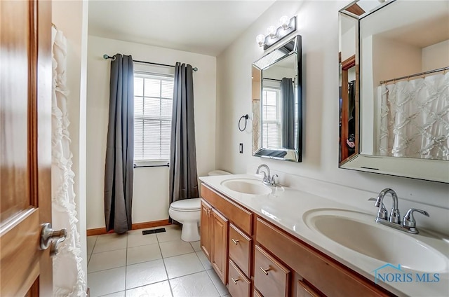 bathroom featuring plenty of natural light, a sink, and tile patterned flooring