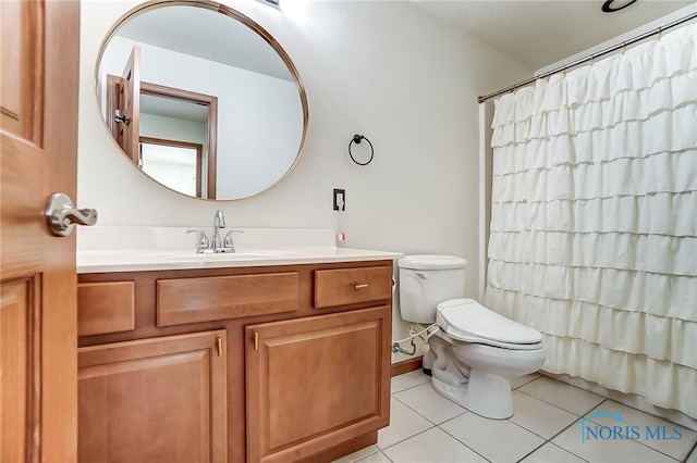 bathroom featuring tile patterned flooring, vanity, and toilet